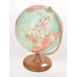 A vintage mid 20th century desk top scan globe set to a circular wooden base.