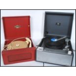 A vintage mid 20th century red vinyl portable three speed  record player by Micrograli together with