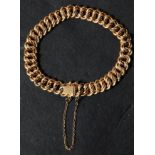 An 18ct carat gold ladies vintage bracelet chain having a fancy engraved link design with hidden