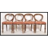 A set of 4 Victorian style balloon back dining chairs being raised on turned legs with overstuffed
