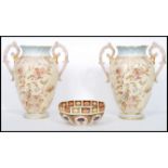 A large pair of Victorian Stafforshire twin handles vases having ivory blush grounds with floral