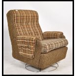 A retro 20th century circa 1970's swivel armchair upholstered in the original fabric and set over