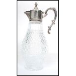 A 20th century silver plated and cut glass claret jug. The silver plated mounts having gadrooned