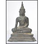 A 19th century Oriental Chinese bronze Buddha modelled in the lotus position raised on a pedestal