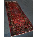 A 20th century Kelim woolen rug / runner , on red ground with a central medallion, inner border with