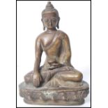 A 19th century Oriental Chinese bronze Buddha modelled in the lotus position holding a pot raised on