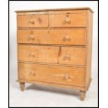 A 19th century Victorian scrubbed pine two short over two long chest of drawers, turned handles