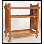 A vintage mid 20th century retro danish influence teak trolley with sliding removable trays raised