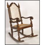 An early 20th century Carolean revival mahogany rocking chair / armchair raised on barley twist