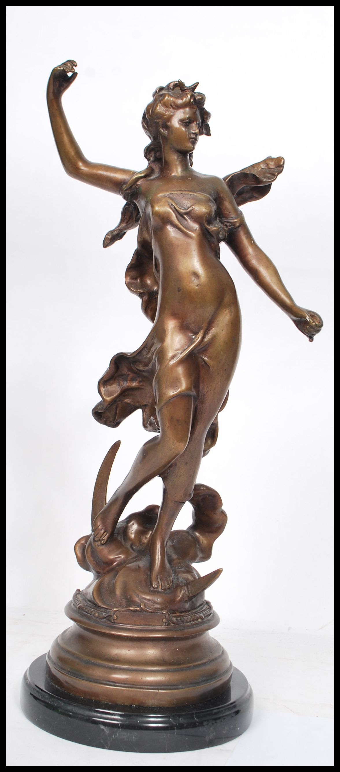 A French bronze figure - sculpture depicting a maiden seated on a crescent moon with cloud after