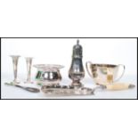 A collection of silver and silver plated items to include a plated wine bottle coaster with