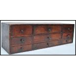 An 18th century Georgian desk tidy of oak construction. The three long drawers having a bank of