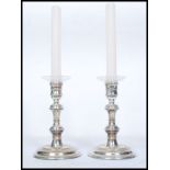A pair of stunning contemporary J A Campbell silver hallmarked turned ( filled ) candle sticks