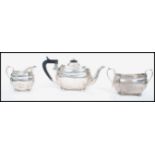 A silver hallmarked 3 piece tea service comprising teapot, sugar pot and creamer. Hallmarked for