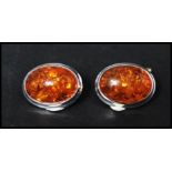 A pair of 925 silver cufflinks set with amber style cabochons. Marked 925.