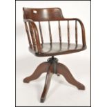 A stunning early 20th century Industrial captains office swivel desk chair. Raised on quadruped base