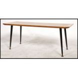 A vintage / retro long teak wood coffee table dating to the mid 20th century raised on ebonised