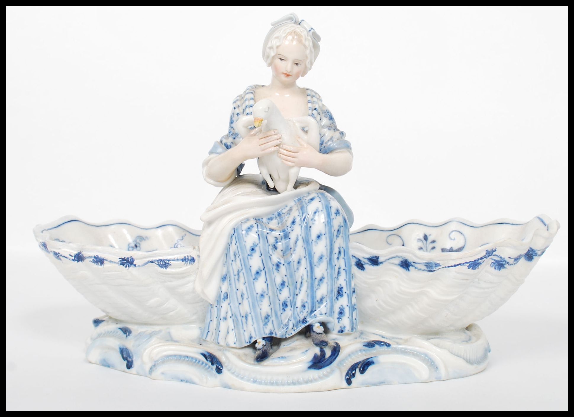 A 19th century Meissen figural table salt modelled as a young girl holding a goose seated between