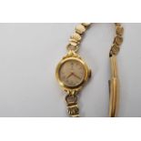 A 20th century  ladies 9ct gold cased bracelet watch by Tudor, having wind up movement set to a