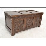 An early 20th century Jacobean revival carved oak coffer chest. The front with carved geometric