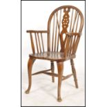 A good early 20th century wheelback windsor armchair raised on cabriole legs having beech and elm