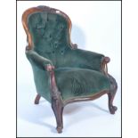 A Victorian mahogany spoon back library chair, with button back green velour upholstery, pad seat