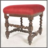 A Victorian barley twist footstool raised on barleytwist supports united by stretchers having an