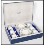 A cased set of six late 20th century bone China unused coffee cans with saucers by Aynsley in the