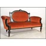 A Victorian mahogany aesthetic movement loving sofa - chesterfield settee. Ebonised with gilt