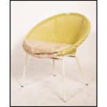 A vintage mid century rattan weave style bedroom chair in yellow colourway with fabric cushion