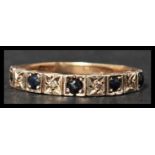 A vintage mid 20th century hallmarked 9ct gold seven stone diamond and sapphire ring. The diamonds