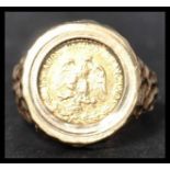A hallmarked 9ct gold ring with Mexican 2 peso 1945 coin Estados Unido Mexicano. The inset coin