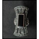 A large 925 silver Art deco style ring set with marcasite and central onyx lozenge. weight 10.8g.