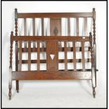 An Antique Edwardian oak barleytwist double bed having slatted head and footboard united by the