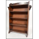 A 1900's Arts & Crafts oak peg jointed open window bookcase cabinet having fixed bank of shelves