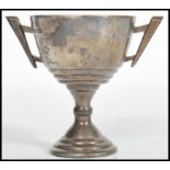 A hallmarked silver trophy cup by Vaughton & Sons bearing assay marks for Birmingham dating to 1937.