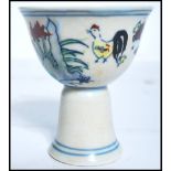 A 19th century Oriental Chinese sake cup depicting flowers with concentric blue circles and blue