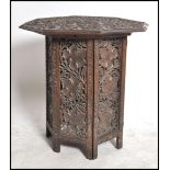 A 19th century black forest carved oak folding table of Octagonal form having carved leaf design