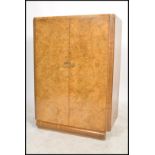 A 1930's Art Deco walnut linen press cupboard. Of low form with shaped plinth  base. Above an