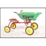 A retro 1970's Triang ' Tippitt ' childs ride on tipper truck bicycle in red with green dumper,