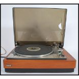 A vintage 20th century Lenco Goldring record player deck set within a teak wood Goodmans case with