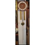 A Vintage 20th century Danish inspired teak wood brass weight driven wall clock