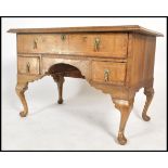 An 18th century Queen Anne walnut lowboy desk of large form. Raised on cabriole legs with pad feet