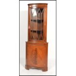 An antique  Georgian style mahogany corner display cabinet with cupboard under astragal glazed