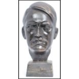 A modern cast iron bust, modelled in the form of Adolf Hitler, on a square base, unsigned, 20cm