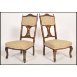 A pair of early 20th century Edwardian mahogany and inlay bedroom chairs having a shaped pierced