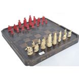 A 19th century Chinese - Canton carved ivory chess set in natural and stained red colourway complete