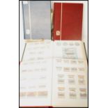A group of four Stanley Gibbons World stamps stock book stamp albums along with two vintage books