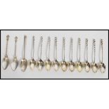 A collection of 10 sterling silver tea spoons with twizzle handles and lozenge shaped bowls. Stamped