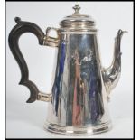 A silver hallmarked coffee pot with ebonised handle. Hallmarked for London, possiblyJosiah Piercy